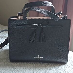 NWOT Black pebbled leather Kate Spade tote with tassel bow detail.